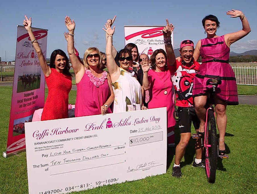 PRETTY IN PINK: Samuel Johnson swamped by Pink Silks Ladies Day committee members on Monday, when they donated $10,000 to the Garvan Institute for “Love Your Sister” breast cancer research.